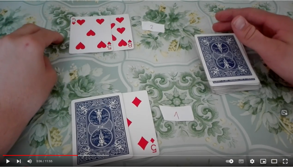 Če igralec želi karto iz kupa, ob kartah pokaže dva prsta navzdol